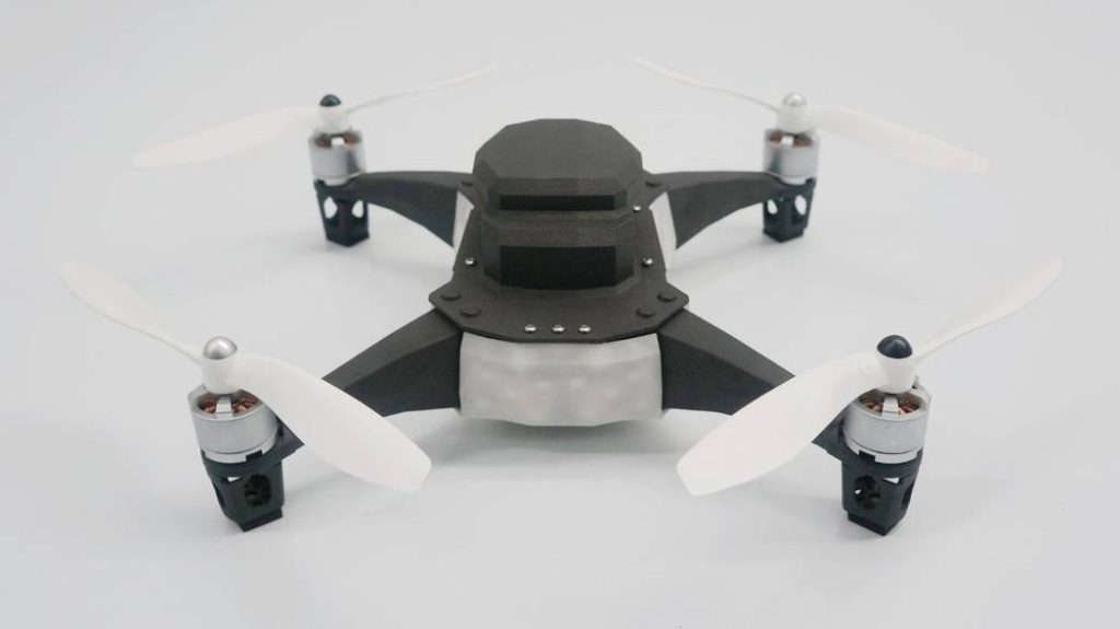 The close-up shows a 3D printed drone, focusing on the intricate design and smooth surface.