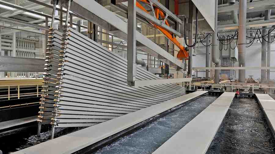 Aluminum profiles being processed in an anodizing plant.