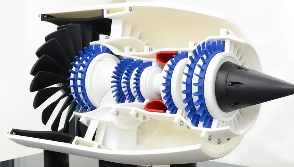 Color-coded jet engine model displaying internal turbine and compressor structure.