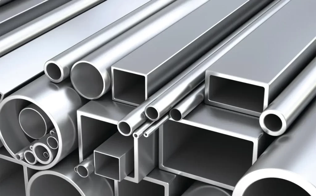 Stack of shiny metal tubes and square profiles made of aluminum.