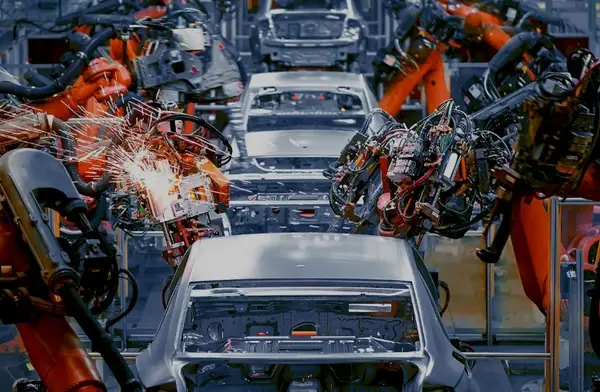 Robotic arms welding car bodies on an automated automotive assembly line