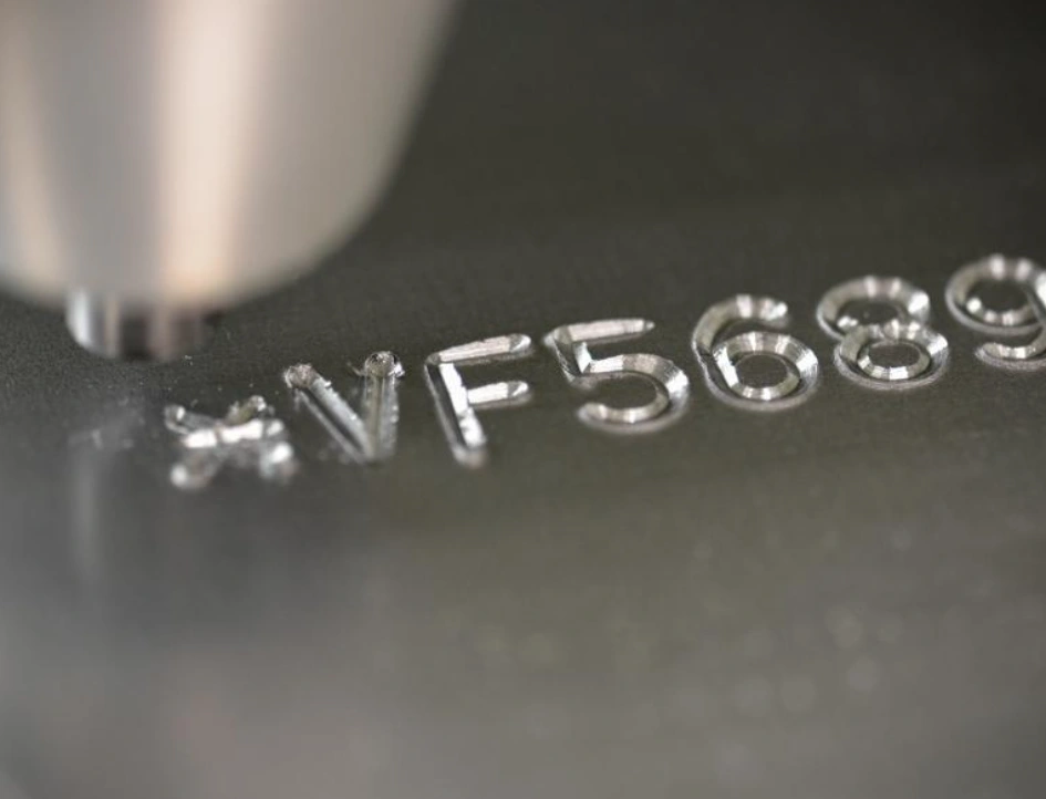 A closeup of a vehicle identification number engraved on a part