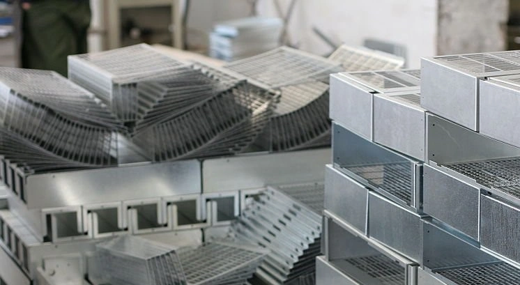 A collection of metallic boxes and trays placed on top of each other