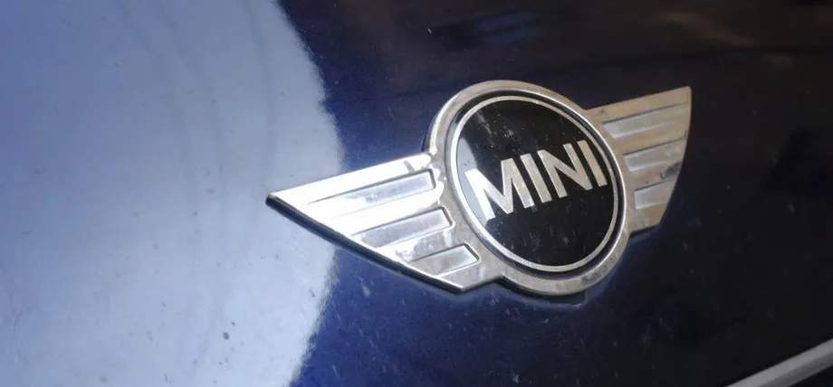 Chrome plated Mini cooper logo on a blue bonnet
