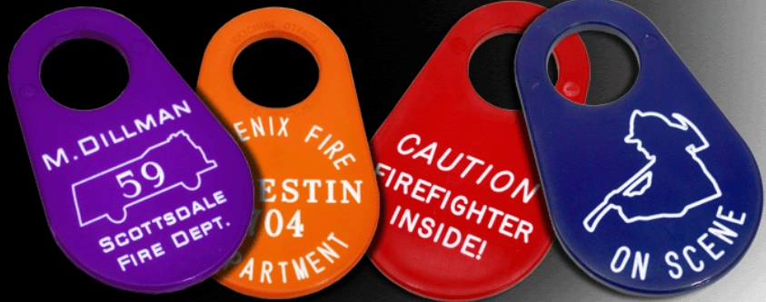 Closeup of CNC engraved purple, yellow, red, and blue plastic tags