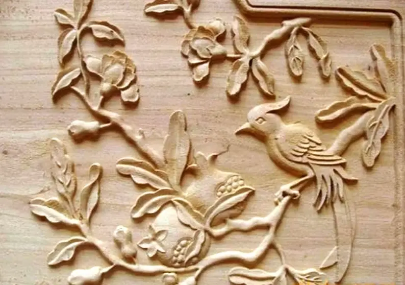 Image of precision CNC engraved bird and branch on a piece of wood