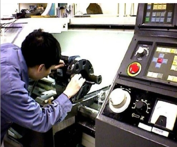 A person checking the components of a CNC router during repair