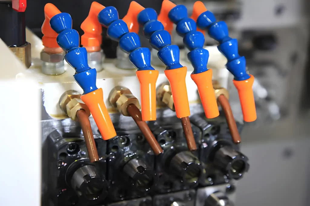 A CNC machine tool is shown with a precise cooling nozzle system directing coolant onto the cutting area.