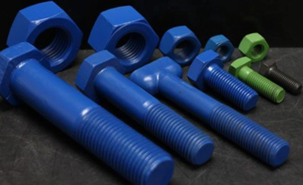 Four blue bolts with nuts, one green bolt with nut, and one smaller grey bolt without a nut on a grey platform