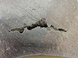 Close-up of porosity defect in a die-cast metal surface