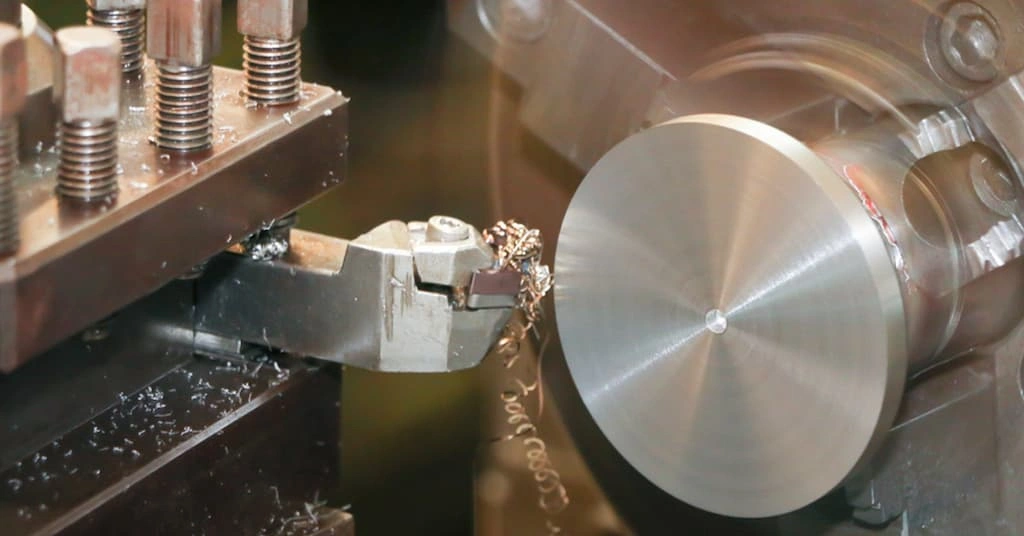 Facing tool refining the end face of cylindrical work on the lathe machine 