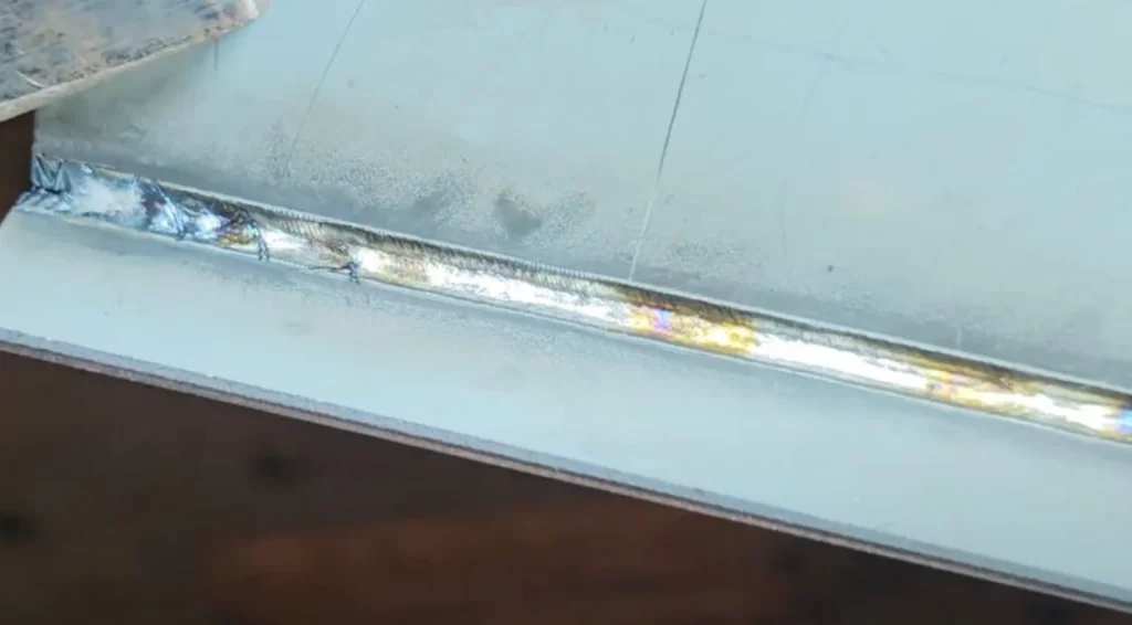 Galvanized steel sheet welding showing bright molten weld seam