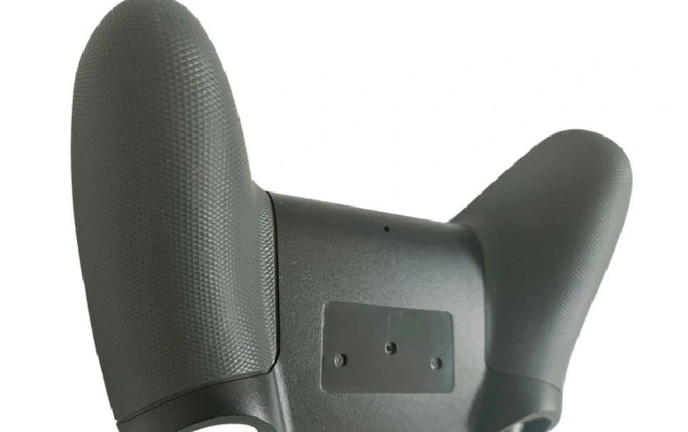An image of a molded game controller handle with a plastic texture for good handling
