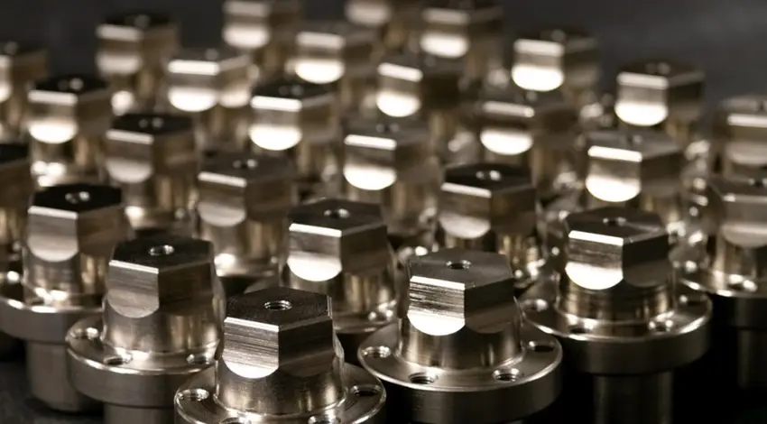 Batch of CNC-machined metal components with precision-milled hexagonal and cylindrical features