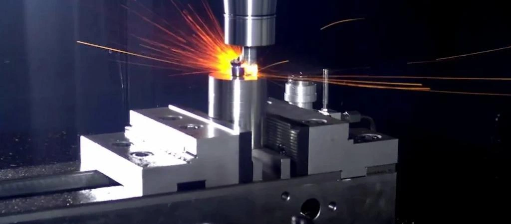 A close-up view of a milling tool machining the Inconel, and a spark coming out 
