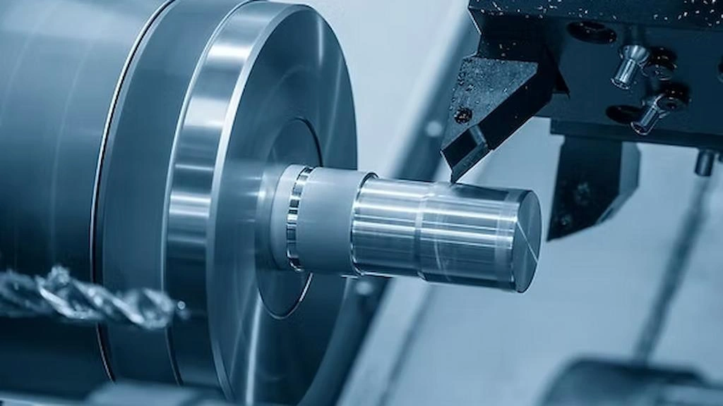A close-up view of lathe machining; a single-point cutter shaping the Inconel rod