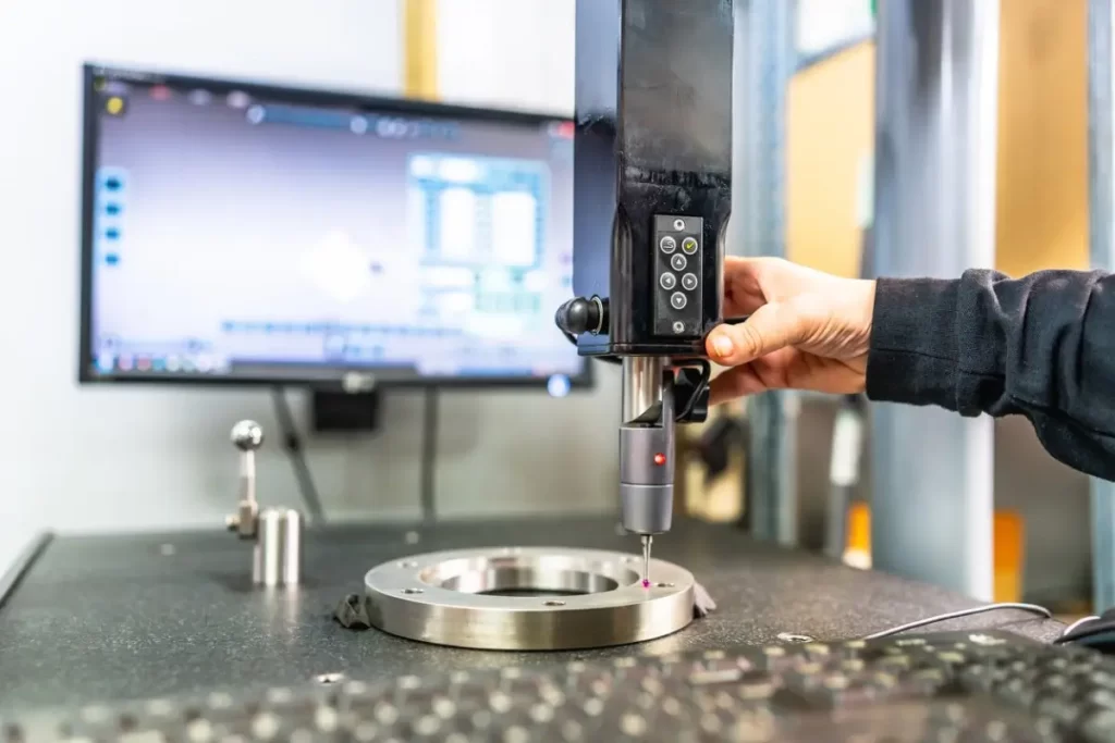 Inspection of a metal casting using precision measuring equipment.