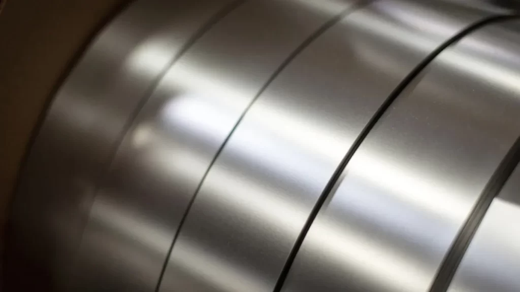 A rolled sheet of martensitic stainless steel displayed in a coiled form. The surface has a slightly matte to semi-gloss finish.