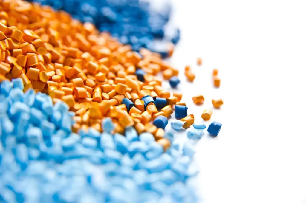 Raw PMMA granules are displayed in bulk. The tiny pellets show the material before molding.