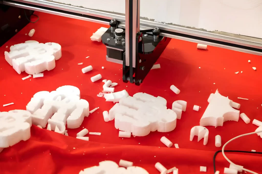 Robot toy being cut and shaped using a polystyrene cutter plotter.