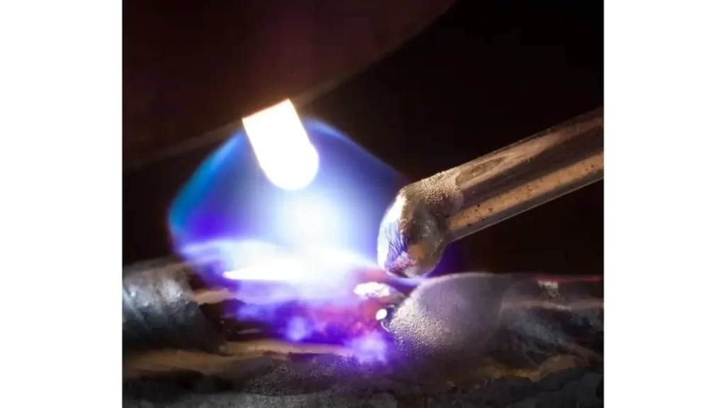Close-up view of shielding gas flowing in a welding process.
