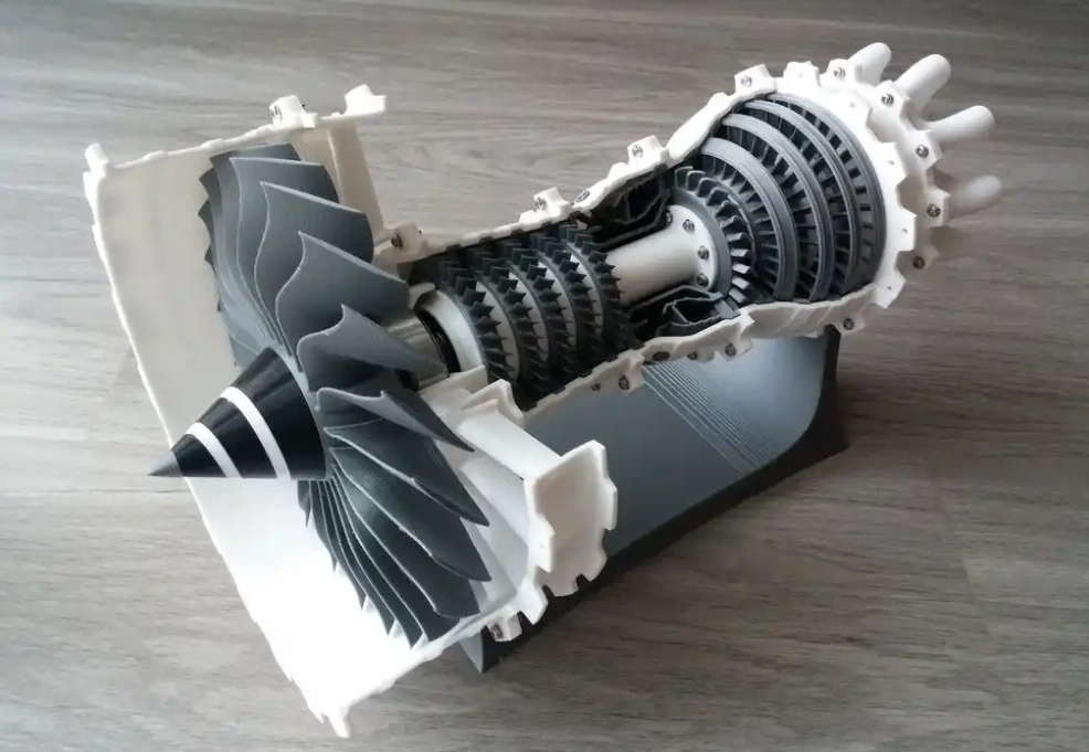 Cross-section of a 3D printed jet engine model showing detailed internal turbine blades and mechanical components