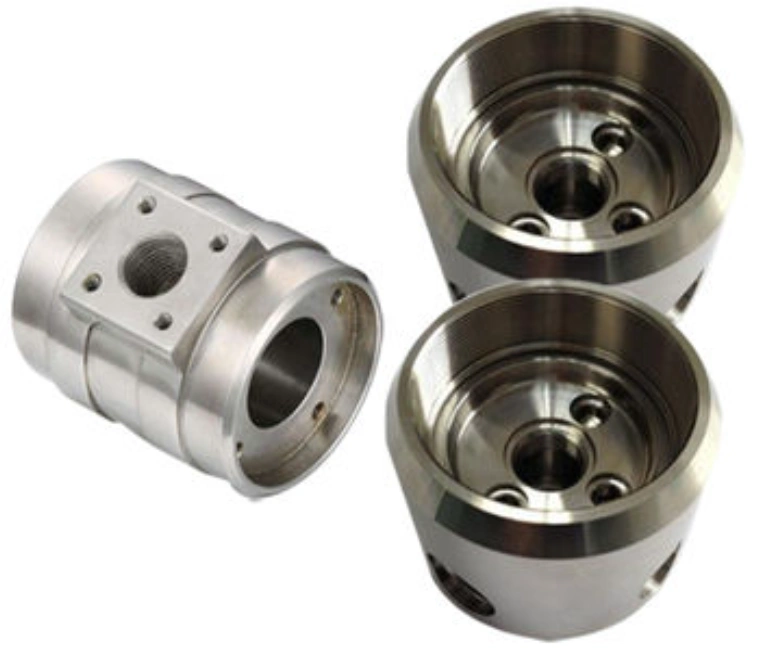 Three precision-machined cylindrical steel prototypes with bored internal features
