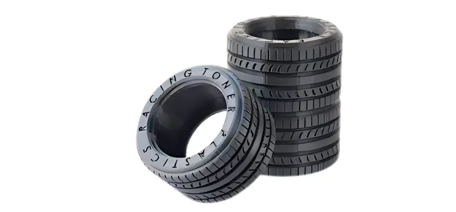 Black stacked tires, plastic flexible with text “racing toner”