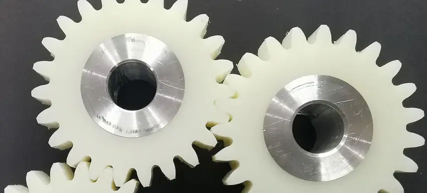White UHMW spur gears with stainless steel hub inserts