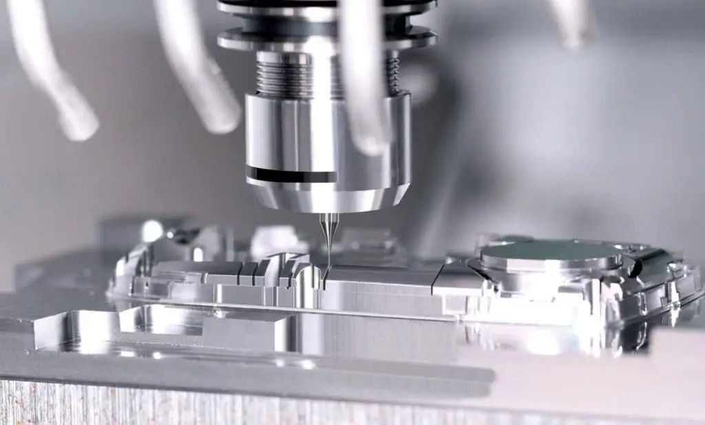 CNC milling machine cutting a metal block with precision.