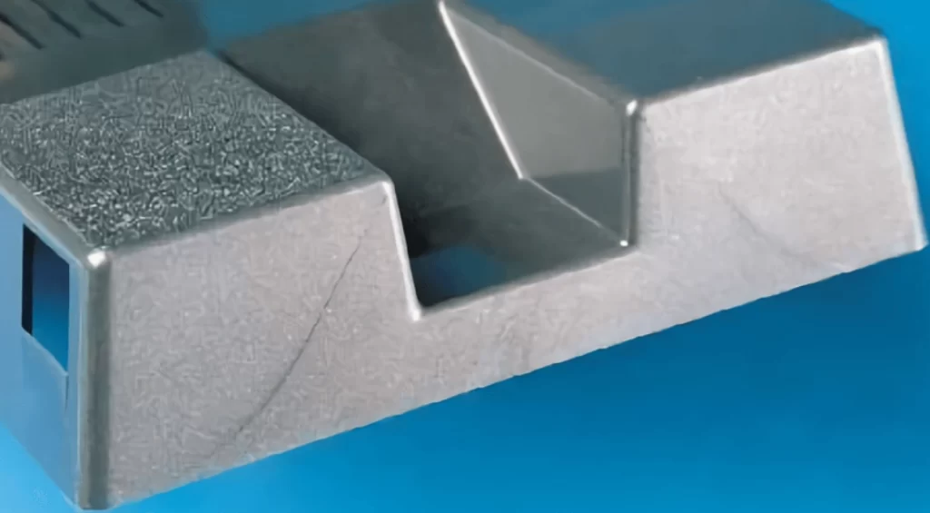 A grey plastic component showing a part of weld lines